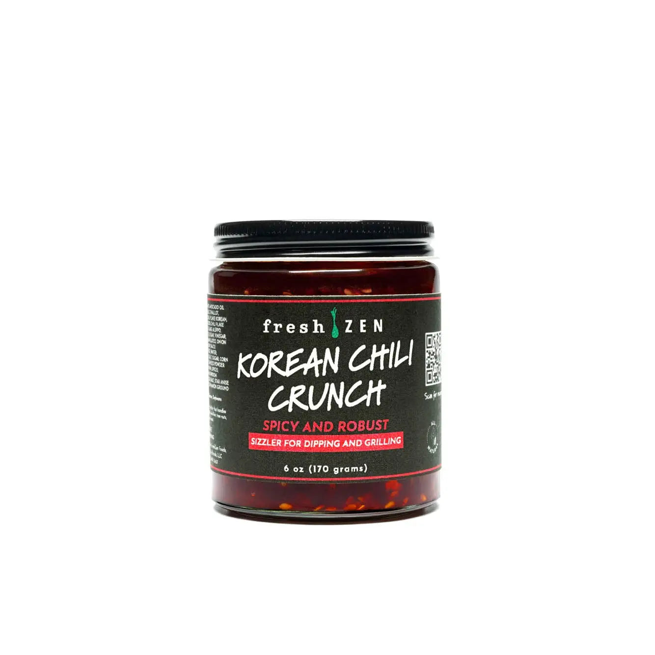 A glass jar of fresh zen korean chili crunch sauce with a black lid and red chili flakes inside