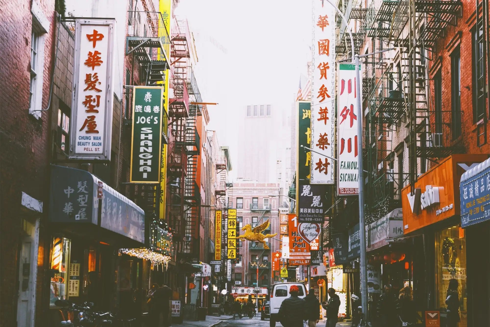 A vibrant, bustling chinatown alleyway lined with colorful neon and led signs in chinese characters.