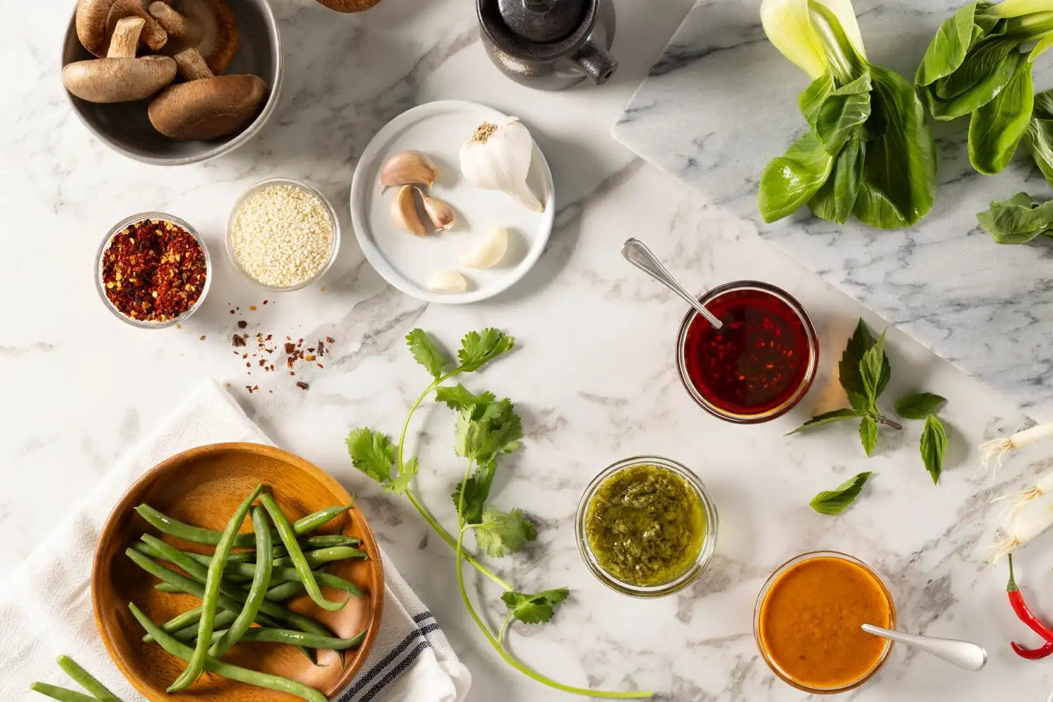 Assorted Asian condiments and ingredients on a marble surface
